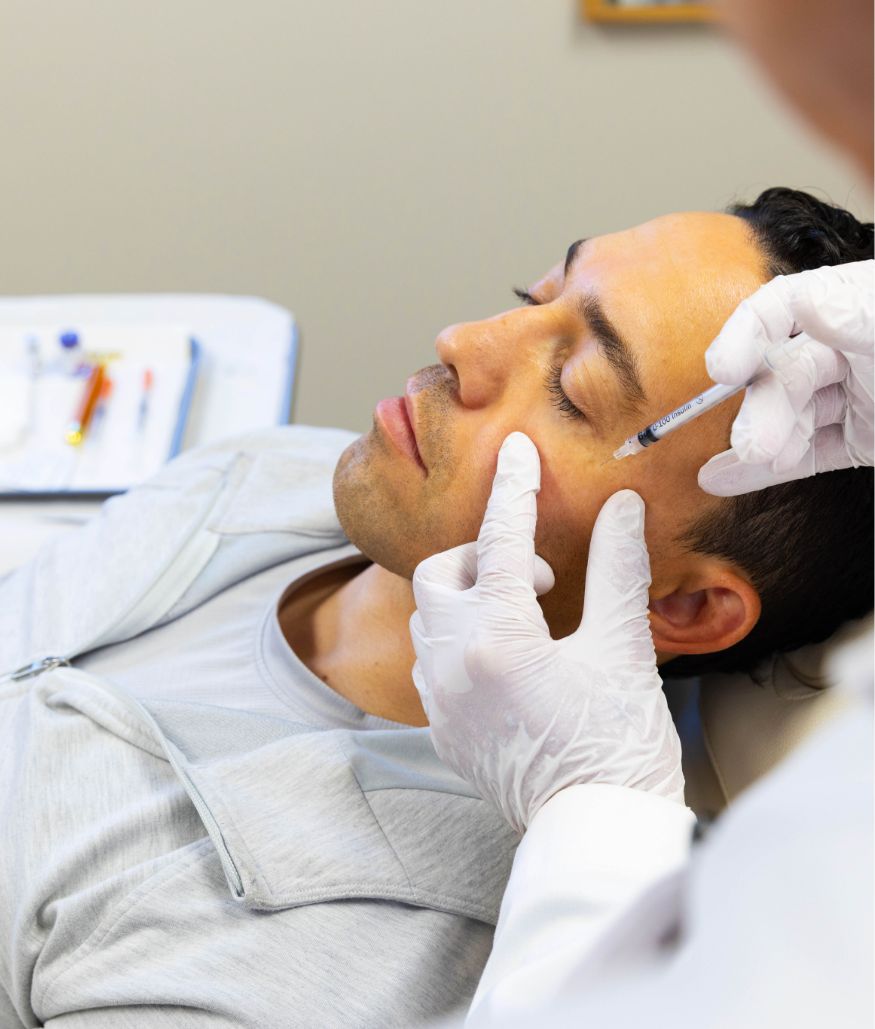 Clinician preparing to inject patient's cheek