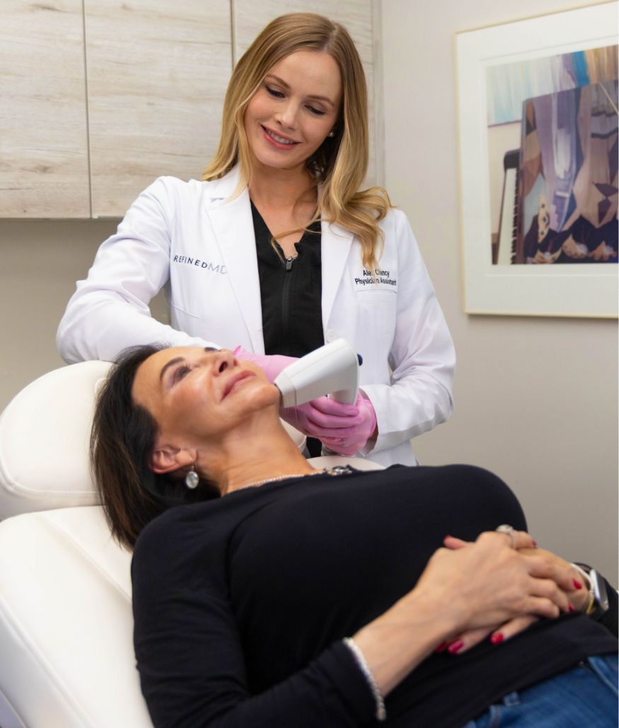 Clinician performs skin-tightening treatment on woman's face