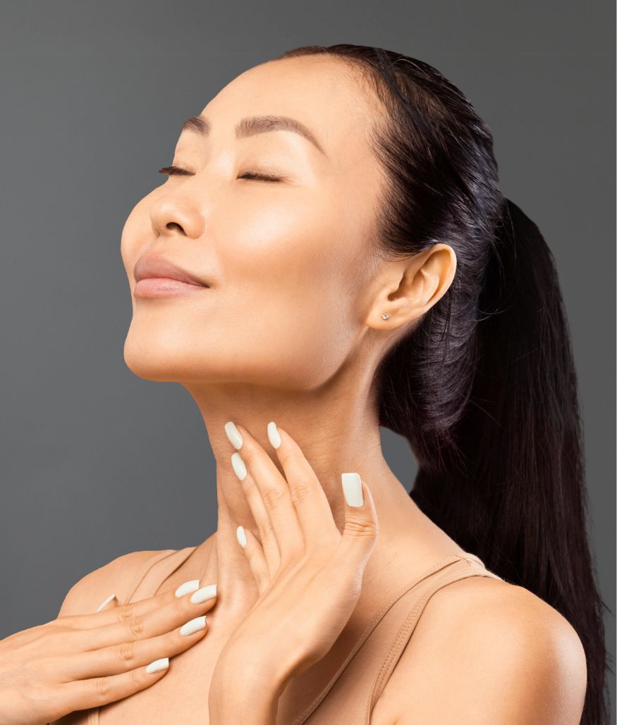 Woman with dark ponytail touching her neck with eyes closed